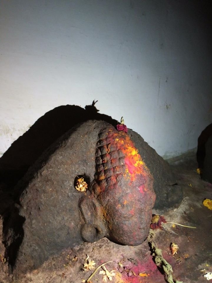 A Bodhisattva idol partly submerged in the new concrete base inside the Kallesvara cave in Kalya, Magadi near Bangalore.